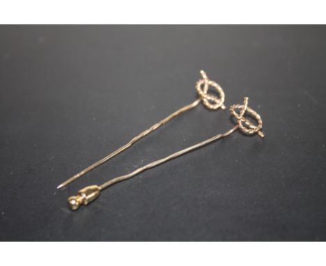 A HALLMARKED 9 CARAT GOLD STAFFORDSHIRE KNOT STICK PIN, together with an unmarked example, approx combined weight 2.9g, H 7 c