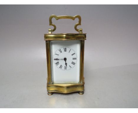 A FRENCH BRASS SERPENTINE FRONTED CARRIAGE CLOCK, H 12 cm