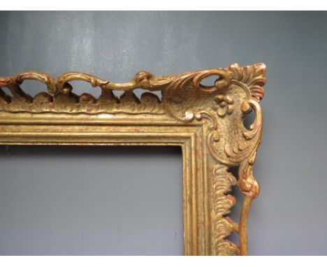AN EARLY 20TH CENTURY CHIPPENDALE STYLE GOLD PIERCED FRAME, frame W 9 cm, frame rebate 52 x 31.5 cmCondition Report:There is 