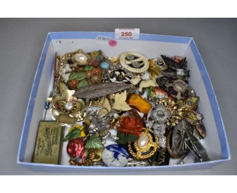 A selection of brooches of various forms including ceramic, mosaic, plastice etc