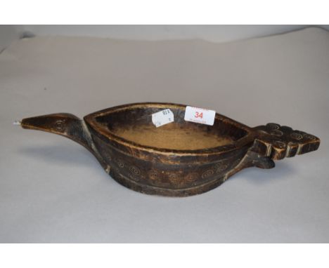 An antique Northern American tribal carved whale oil lamp filler
