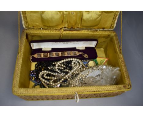 A seagrass sewing box containing a selection of costume jewellery including simulated pearls and gold plated gate bracelet et