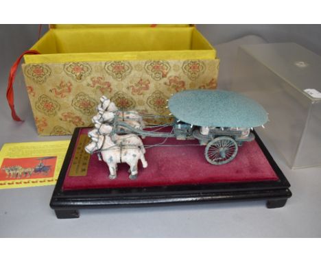 A model of a Chinese chariot and scroll