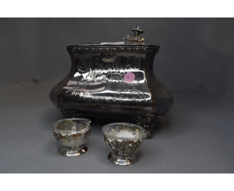 A silver plated tea caddy by Skinner &amp; Co having moulded floral decoration and bracket feet, no liner and finial damaged,