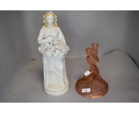 An art deco pink pressed glass lamp stand and a parian ware figure