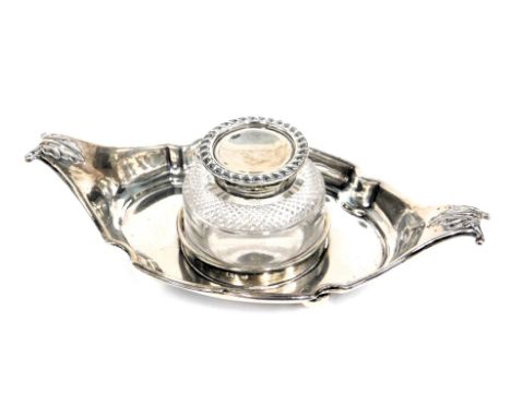 A Victorian silver inkstand, the shaped boat with moulded leaf thumb pieces, with a circular cut glass inkwell with a silvere