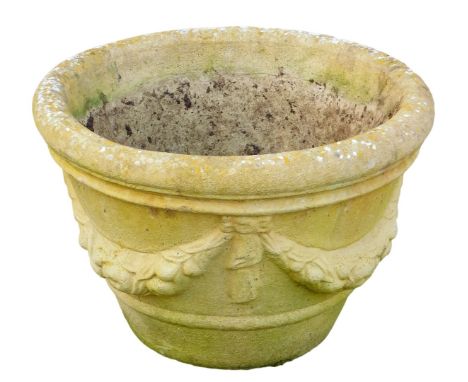 A reconstituted stone planter, with a moulded rim decorated with swags and flowers, 33cm high, 51cm wide. 