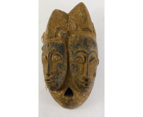 A Baule Old 'Janus' two faced portrait mask (Mblo), Cote D'Ivoire, 36cm high. 