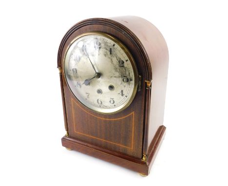 An Edwardian mahogany and boxwood strung mantel clock, the arched case with gilt metal mounts, silvered dial and Westminster 