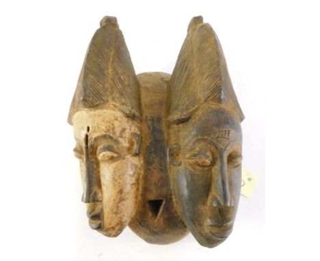 A Baule Old 'Janus' two faced portrait mask (Mblo), Cote D'Ivoire, 39cm high. 