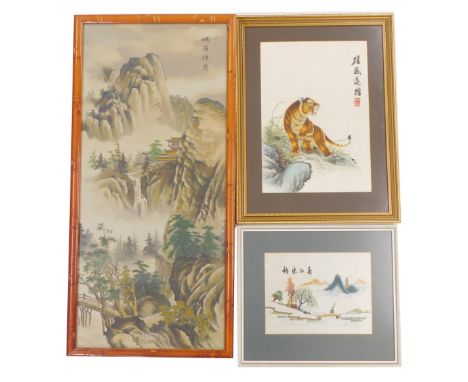 Three Oriental pictures, comprising a Chinese pine framed mountainous print, 92cm x 40cm, a silk embroidery of a tiger on roc