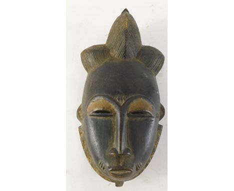 An Old Mblo portrait mask with encrusted patina, Cote D'Ivoire, 33cm high. 