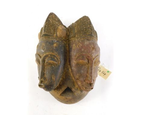 A Baule Old 'Janus' two faced portrait mask (Mblo), Cote D'Ivoire, 40cm high. 