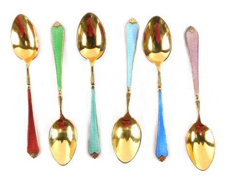A cased set of six George V silver gilt enamel teaspoons, with red, green, teal, light blue, dark blue, and pink enamel detai