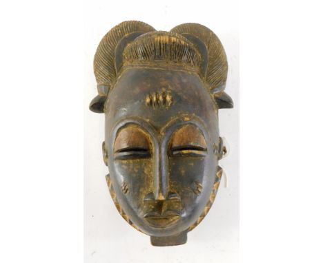 A Baule Mblo spiritual portrait mask with elaborate coiffure, Cote D'Ivoire, 32cm high. 