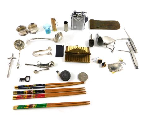 A group of curios and trinkets, comprising a pair of silver plated napkin rings, Art Nouveau cased brass tape measure, chopst