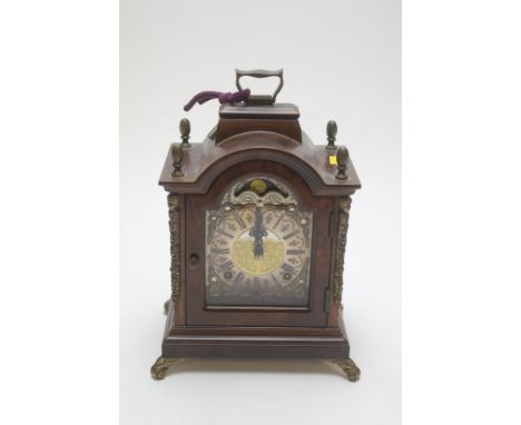 A walnut cased mantel clock by Wuba, marked 'Warmink', with roman dial and sundial above, 26cms high.
