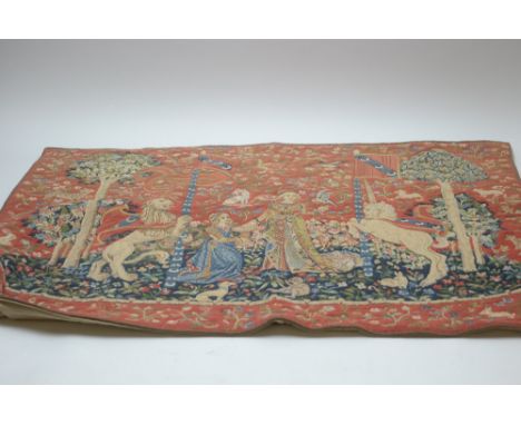 A Victorian needlework tapestry of figures in a mythical garden, on red ground, 95cms wide.