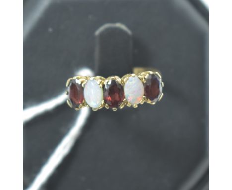 Garnet and opal ring, in 9ct yellow gold crown mount and shank, ring size K.