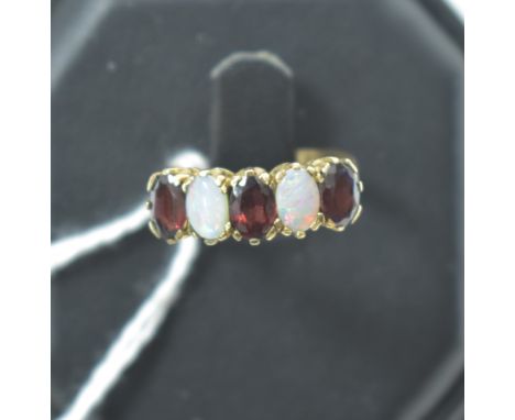 Garnet and opal ring, in 9ct yellow gold crown mount and shank, ring size K.