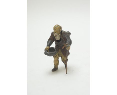 An early 20th Century cold painted metal nodding figure of an old man with peg leg leaning on a stick and holding his hat, 8c