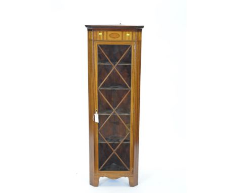 A 20th Century mahogany and satinwood inlaid corner cabinet, with dentil moulded cornice above an astragal glazed door, above