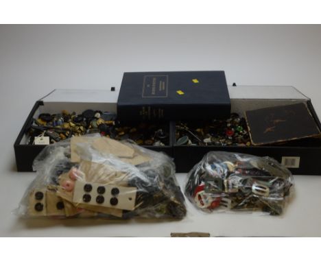 A larege collection of mixed antique buttons of varying sizes; together with a bag of vintage buckles; and a book entitled 'T