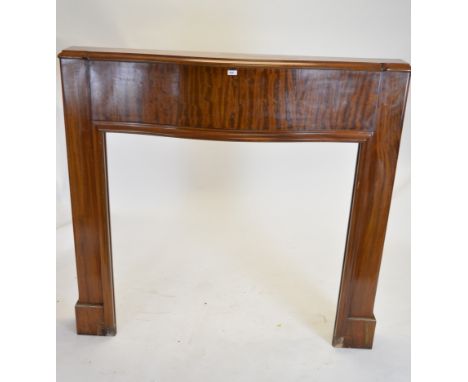 A 20th Century mahogany bowfronted fire surround, 134 x 140 x 24cms.