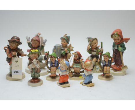 A tray of eleven Hummel/Goebel figures, including: salt and pepper skiers; boy on a sledge; boy with a lamb; violinist; and o