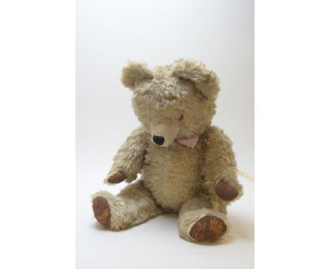 A large vintage articulated teddy bear, 70cms long.