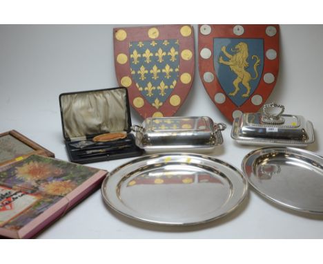 Silver plate, to include: trays and tureens; together with painted coat of arms plaques; a framed needlework tapestry of Adam
