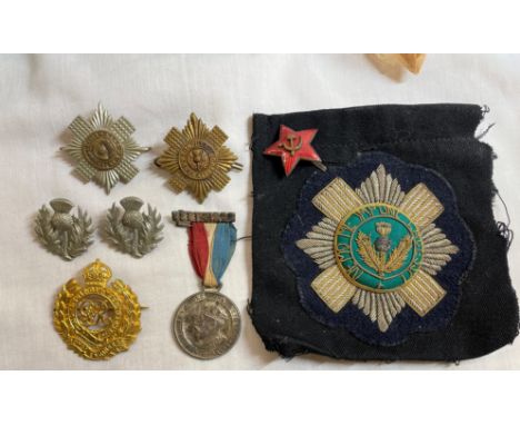 BOX OF REGIMENTAL CAP BADGES, ENAMEL SOVIET STAR BADGE, SEW-ON PATCH AND OTHER MEDAL