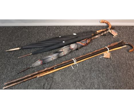 Selection of walking canes and parasols. Includes Black watch swagger stick, Horn handle and glass effect handle parasol [Wil