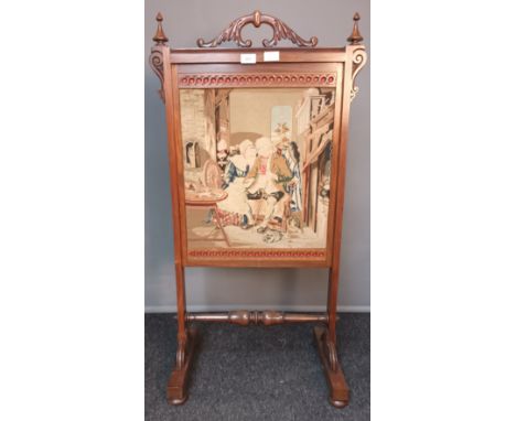 19th century fire screen, the carved handle above a rosewood frame, the centre with needlework tapestry, raised on trestle ba