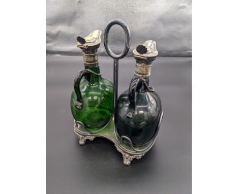 Pair of antique green glass decanters with plated collar and stoppers, within a plated caddy [28cm] 