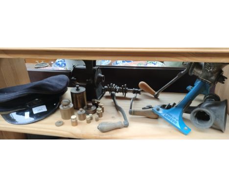 Shelf of interesting items includes vintage mincer tools , brass weights, military hat etc . 