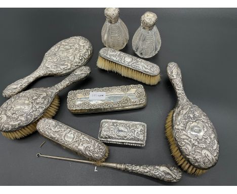 Collection of silver dressing table items to include two lidded boxes [218grams] Four ornate hand brushes, hand mirror, butto