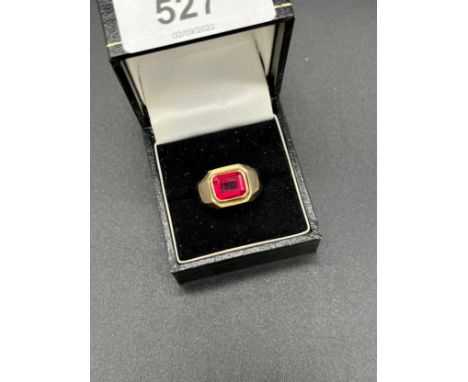 Gold ring set with an emerald cut Ruby. [Stamped S700- Foreign 18ct gold] [8.60grams] [Ring size O] 