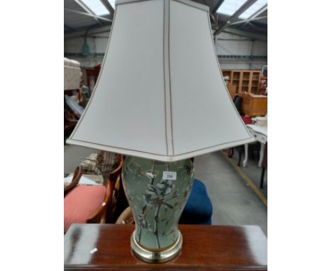 Large interior table lamp depicting birds fitted with a shade. 