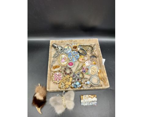 Box of costume brooches to include Fur butterfly brooch, Spider brooch with opalescent stone, Sterling silver and enamel boat