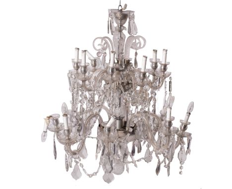 A cut glass sixteen light chandelier in Louis XV taste, 20th century; the two tiers each of eight sconces on scrolling branch