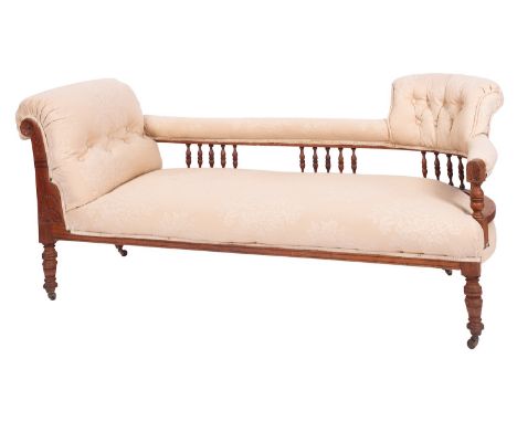 An Edwardian walnut and button upholstered chaise longue, early 20th century; with outscrolled end, the padded back rail on b
