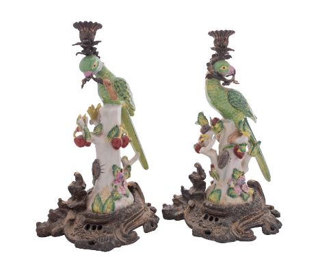 A pair of reproduction ceramic and gilt-metal mounted parrot candlesticks, 37cm.