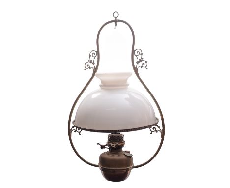 A late Victorian brass and milk glass hanging oil lamp, circa 1900; the domed shade with open vent, on a circlet held on scro