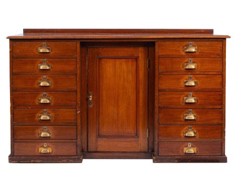 An Edwardian mahogany draper's counter, early 20th century; the top with raised back and moulded edges; the front with recess