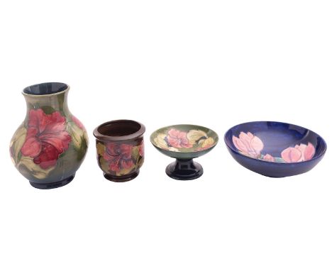 Four pieces of Walter and John Moorcroft pottery comprising a vase, planter and comport tube lined in the Hibiscus pattern on