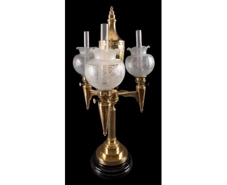 A French gilt metal three light table oil lamp, late 19th century; with repousse worked urn reservoir above three horizontal 