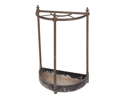 A brass and painted zinc stick stand, early 20th century; of demi-lune form, the top with three urn finials, on straight rods