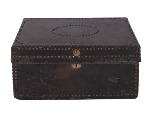 A leather covered and brass studded wood coaching trunk, second quarter 19th century; with brass swing handles at the ends; t