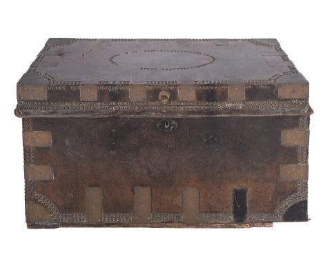 A George III brass bound and studded leather trunk, circa 1800; the strengthening plates at the corners and angles; with iron